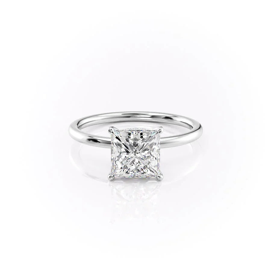 The Nelly. A White Gold Solitaire, Hidden Halo Engagement Ring Set With A 2ct Princess Lab Grown Diamond. White Background.