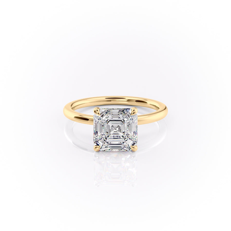 The Nelly. A Yellow Gold Solitaire, Hidden Halo Engagement Ring Set With A 2ct Asscher Lab Grown Diamond. White Background.