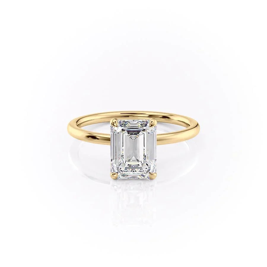 The Nelly. A Yellow Gold Solitaire, Hidden Halo Engagement Ring Set With A 2ct Emerald Lab Grown Diamond. White Background.