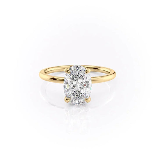 The Nelly. A Yellow Gold Solitaire, Hidden Halo Engagement Ring Set With A 2ct Oval Lab Grown Diamond. White Background.