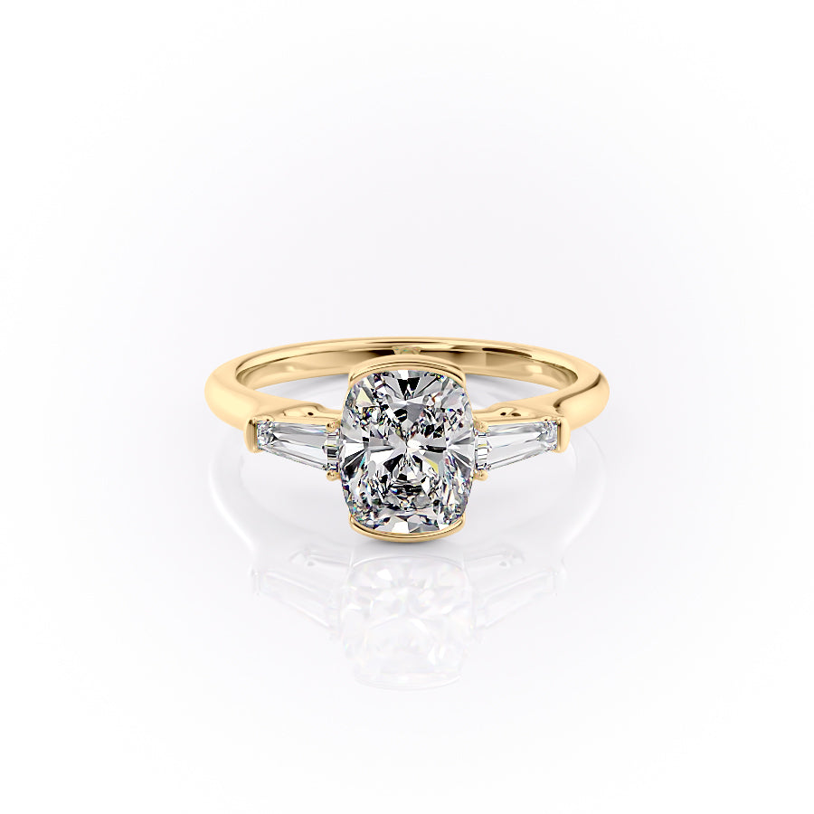The Parker. A Yellow Gold Three Stone, Bezel Engagement Ring Set With A 2ct Elongated Cushion Lab Grown Diamond. White Background.