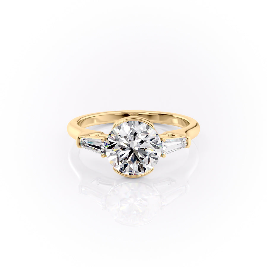 The Parker. A Yellow Gold Three Stone, Bezel Engagement Ring Set With A 2ct Round Lab Grown Diamond. White Background.
