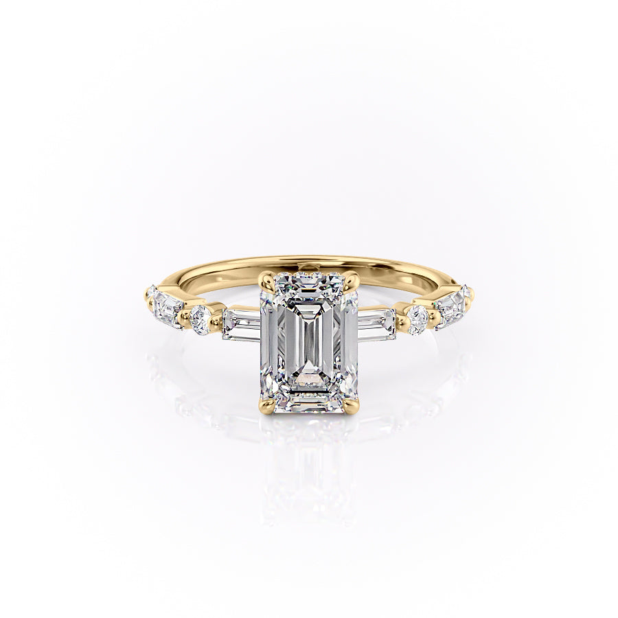 The Patricia. A Yellow Gold Side Stones, Hidden Halo Engagement Ring Set With A 2ct Emerald Lab Grown Diamond. White Background.