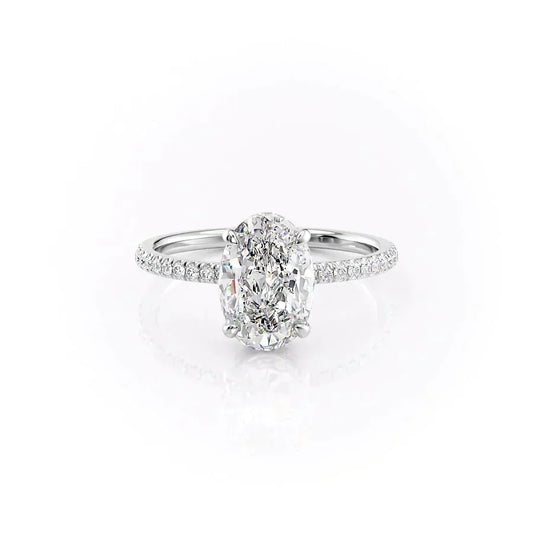 The Pave Aline. A White Gold Hidden Halo Engagement Ring Set With A 2ct Oval Lab Grown Diamond. White Background.