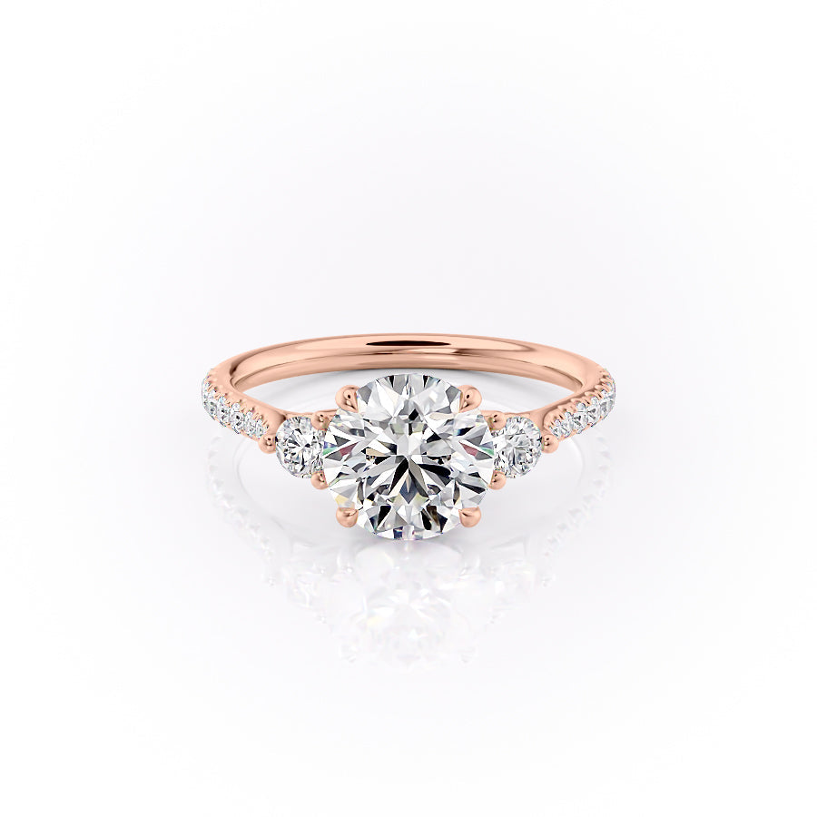 The Pave Lia. A Rose Gold Three Stone Engagement Ring Set With A 2ct Round Lab Grown Diamond. White Background.