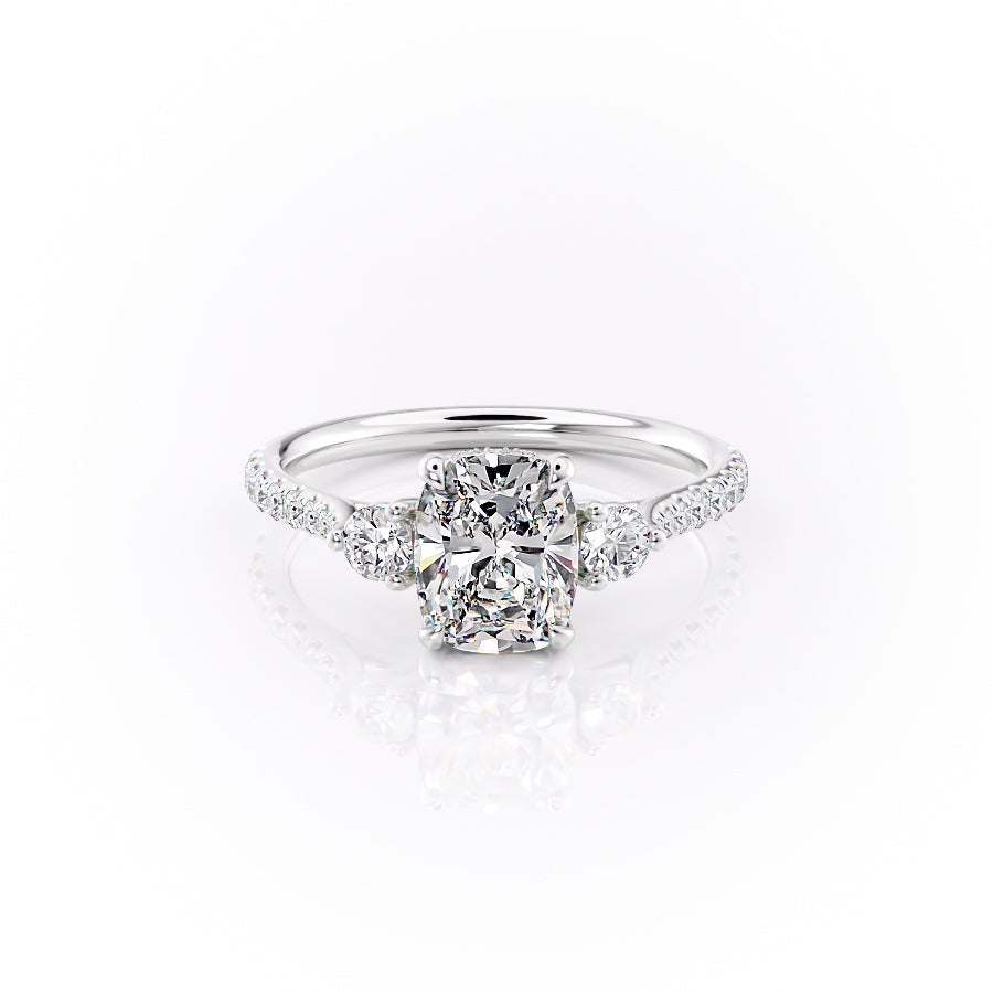 The Pave Lia. A White Gold Three Stone Engagement Ring Set With A 2ct Elongated Cushion Lab Grown Diamond. White Background.