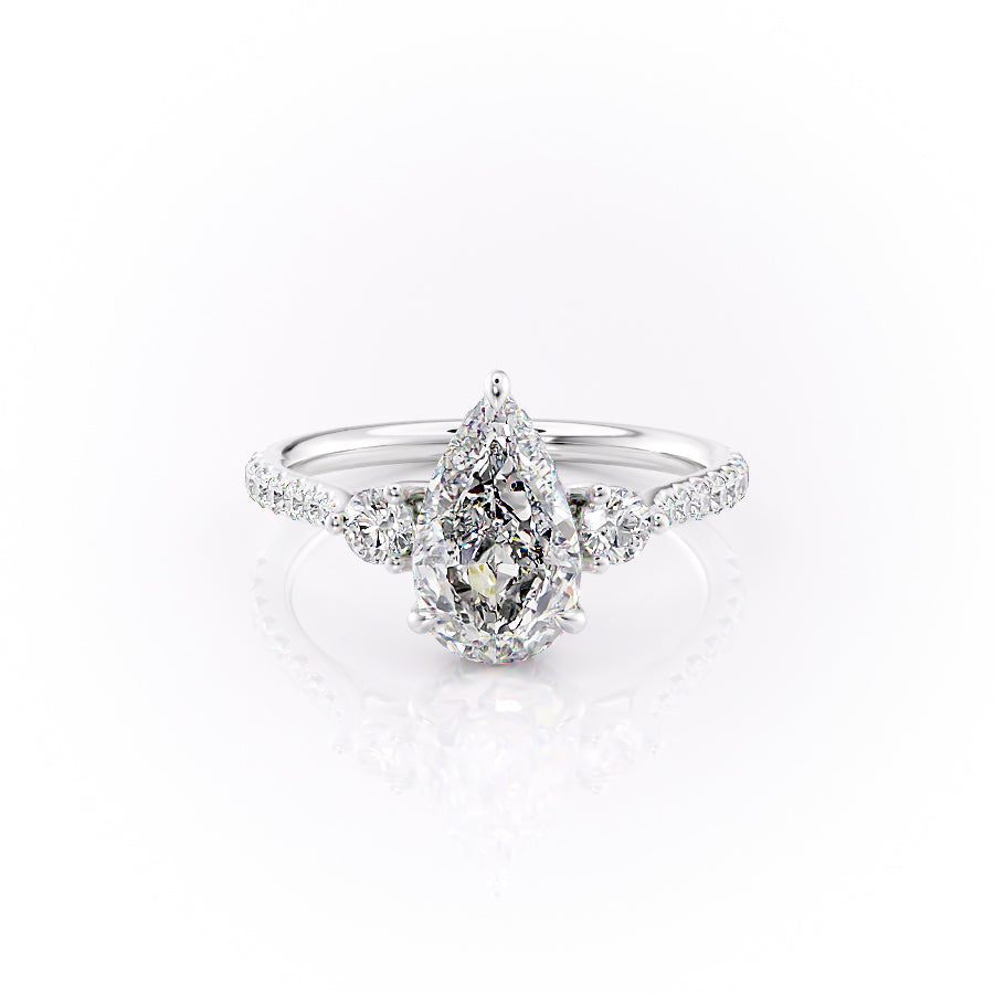 The Pave Lia. A White Gold Three Stone Engagement Ring Set With A 2ct Pear Lab Grown Diamond. White Background.