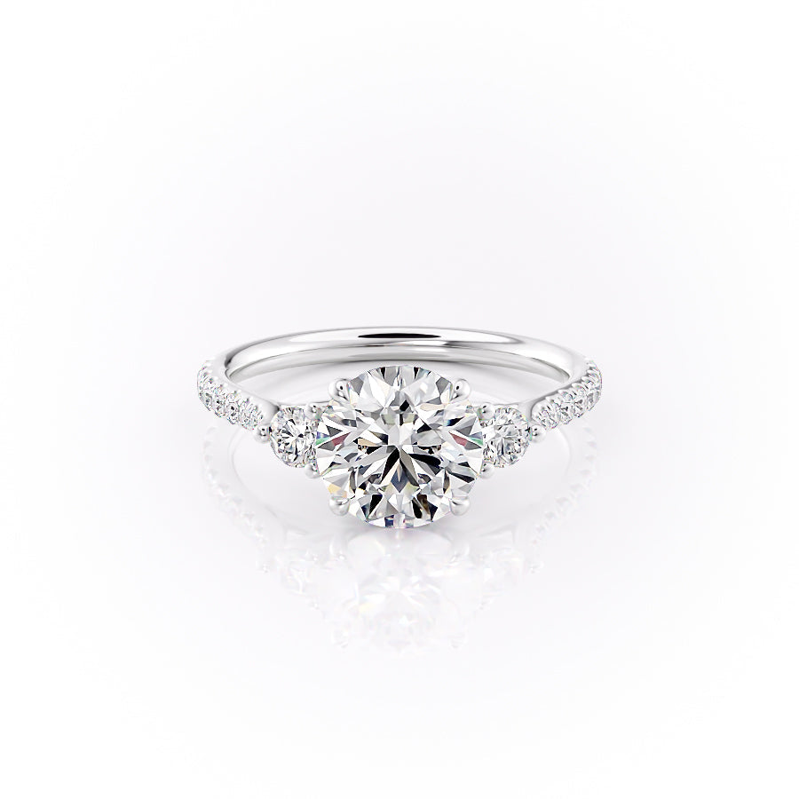 The Pave Lia. A White Gold Three Stone Engagement Ring Set With A 2ct Round Lab Grown Diamond. White Background.
