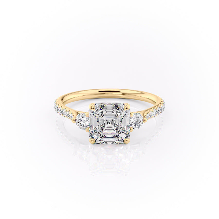 The Pave Lia. A Yellow Gold Three Stone Engagement Ring Set With A 2ct Asscher Lab Grown Diamond. White Background.