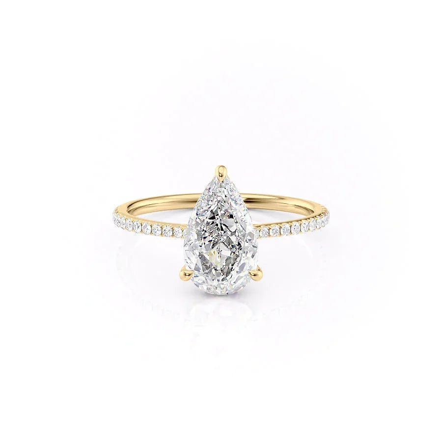 The Pave Maia. A Yellow Gold Hidden Halo Engagement Ring Set With A 2ct Pear Lab Grown Diamond. White Background.