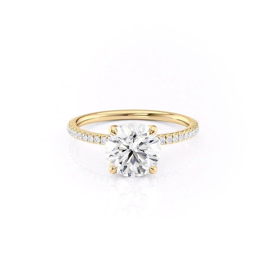 The Pave Nelly. A Yellow Gold Hidden Halo Engagement Ring Set With A 2ct Round Lab Grown Diamond. White Background.