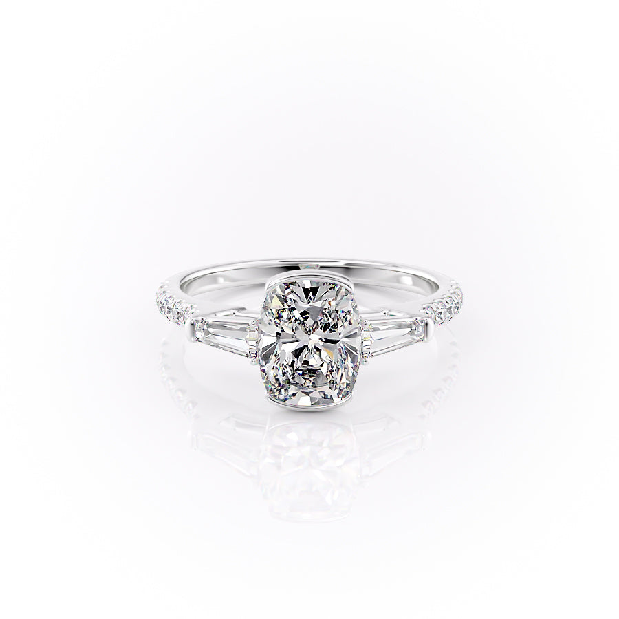 The Pave Parker. A White Gold Three Stone, Bezel Engagement Ring Set With A 2ct Elongated Cushion Lab Grown Diamond. White Background.