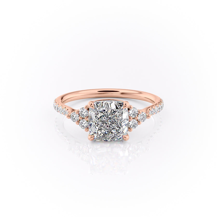 The Pave Scarlett. A Rose Gold Three Stone, Side Stones Engagement Ring Set With A 2ct Cushion Lab Grown Diamond. White Background.