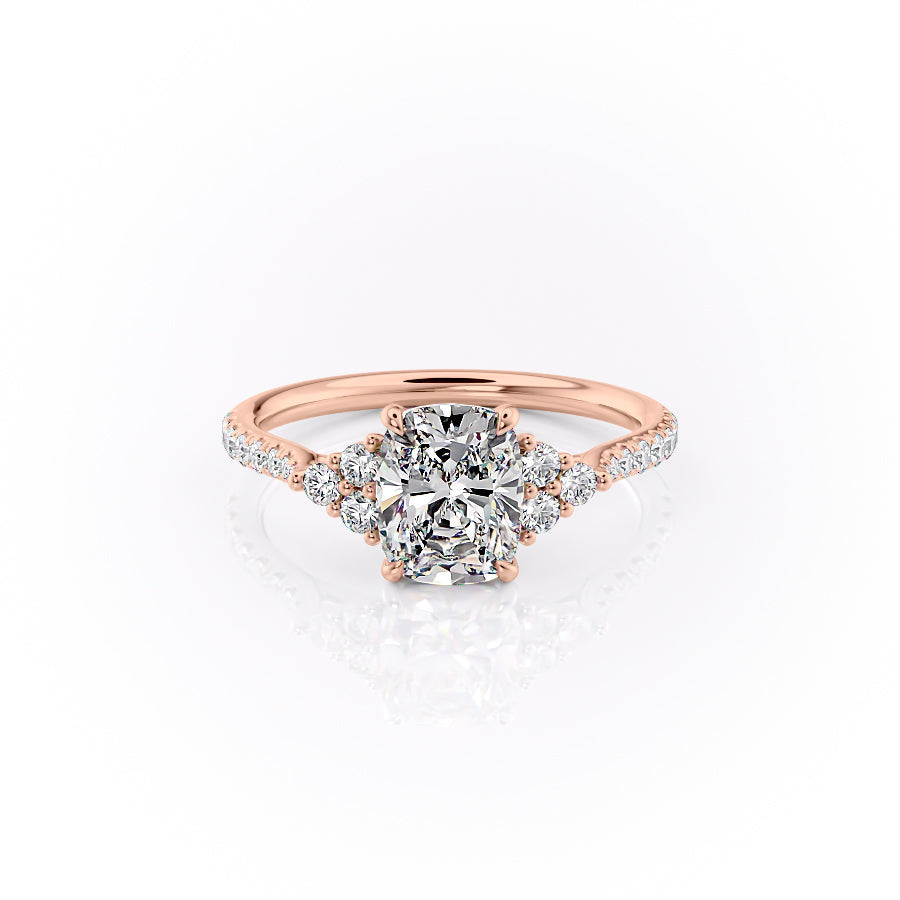 The Pave Scarlett. A Rose Gold Three Stone, Side Stones Engagement Ring Set With A 2ct Elongated Cushion Lab Grown Diamond. White Background.