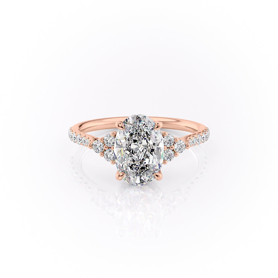 The Pave Scarlett. A Rose Gold Three Stone, Side Stones Engagement Ring Set With A 2ct Oval Lab Grown Diamond. White Background.