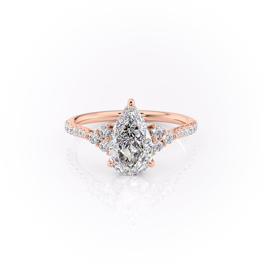 The Pave Scarlett. A Rose Gold Three Stone, Side Stones Engagement Ring Set With A 2ct Pear Lab Grown Diamond. White Background.