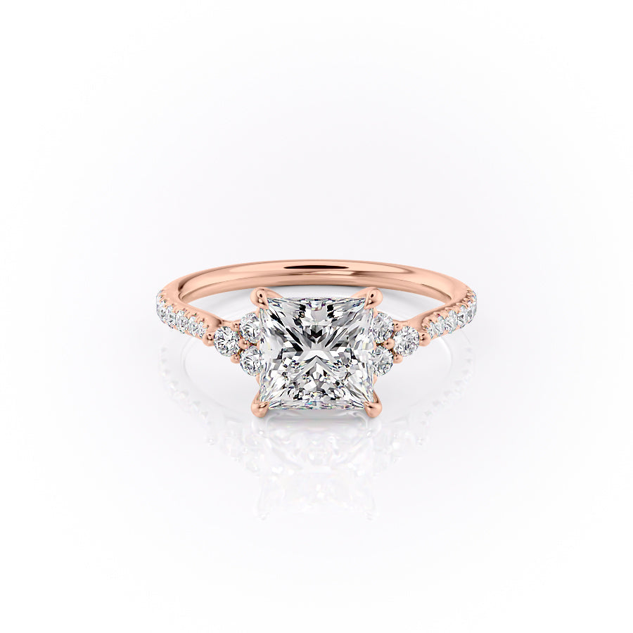 The Pave Scarlett. A Rose Gold Three Stone, Side Stones Engagement Ring Set With A 2ct Princess Lab Grown Diamond. White Background.