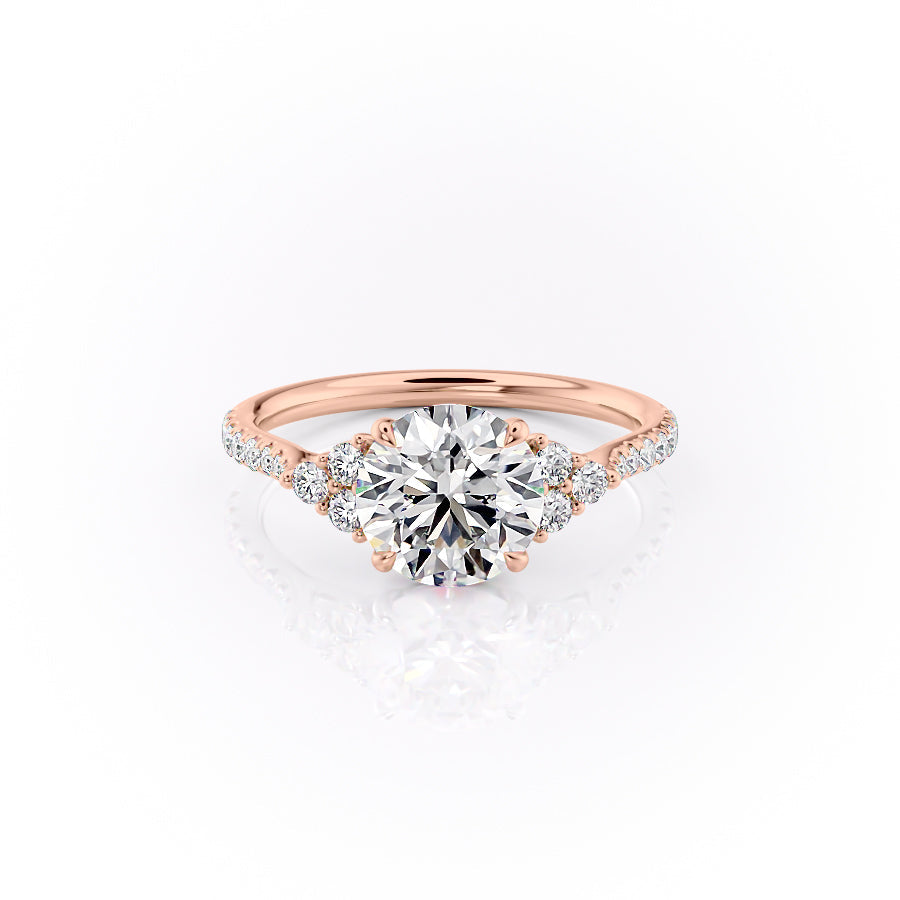 The Pave Scarlett. A Rose Gold Three Stone, Side Stones Engagement Ring Set With A 2ct Round Lab Grown Diamond. White Background.