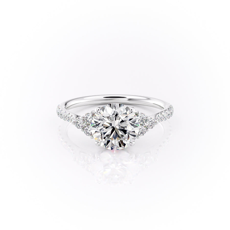 The Pave Scarlett. A White Gold Three Stone, Side Stones Engagement Ring Set With A 2ct Round Lab Grown Diamond. White Background.