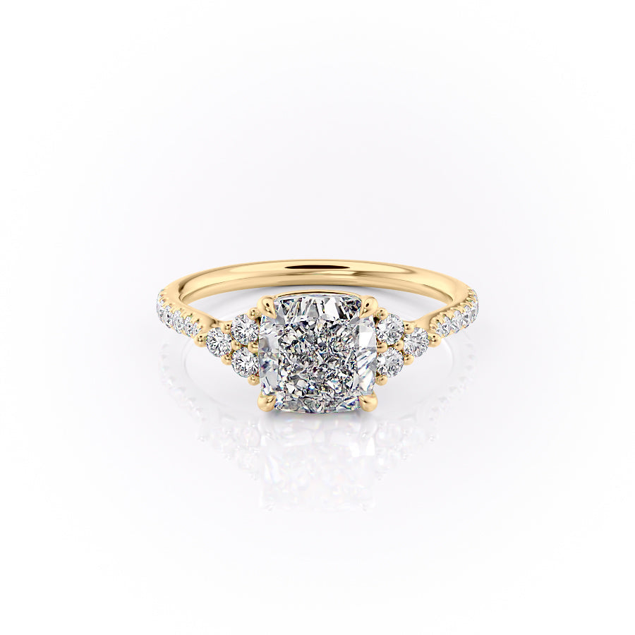 The Pave Scarlett. A Yellow Gold Three Stone, Side Stones Engagement Ring Set With A 2ct Cushion Lab Grown Diamond. White Background.