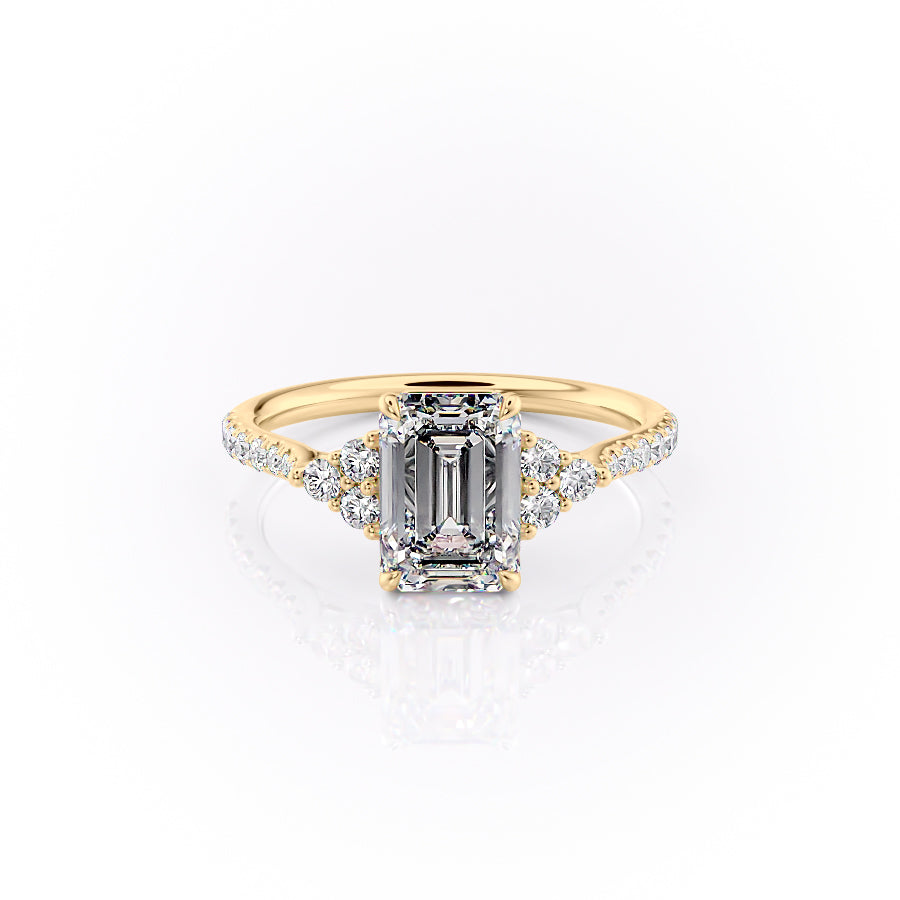 The Pave Scarlett. A Yellow Gold Three Stone, Side Stones Engagement Ring Set With A 2ct Emerald Lab Grown Diamond. White Background.