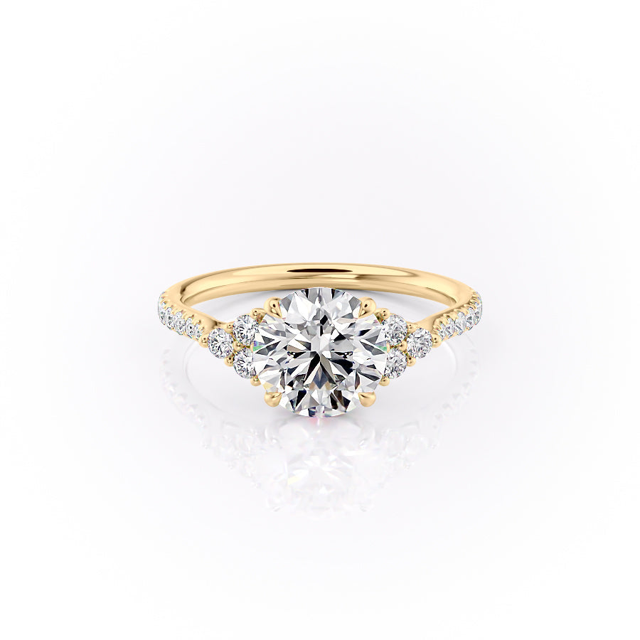 The Pave Scarlett. A Yellow Gold Three Stone, Side Stones Engagement Ring Set With A 2ct Round Lab Grown Diamond. White Background.