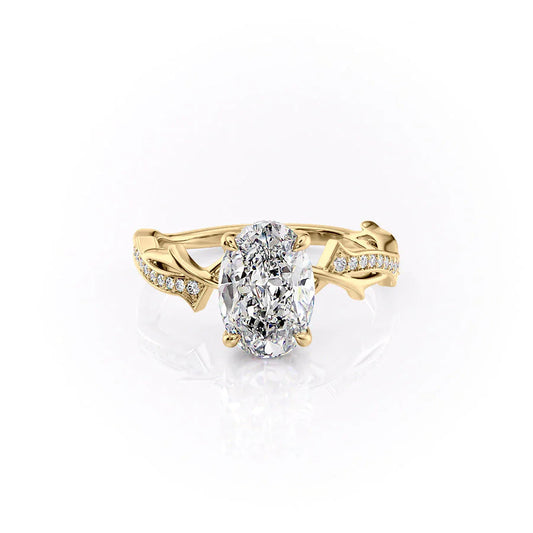 The Pave Twig. A Yellow Gold Nature, Hidden Halo Engagement Ring Set With A 2ct Oval Lab Grown Diamond. White Background.