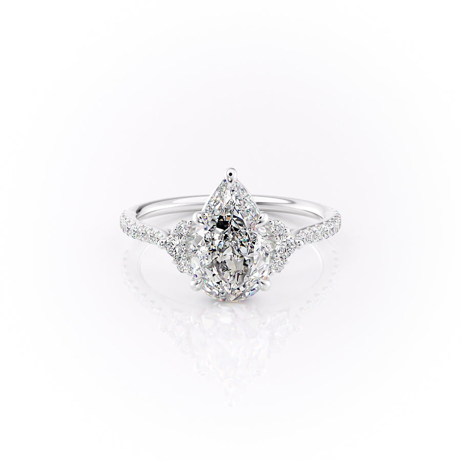 The Pave Victoria. A White Gold Three Stone, Side Stones Engagement Ring Set With A 2ct Pear Lab Grown Diamond. White Background.