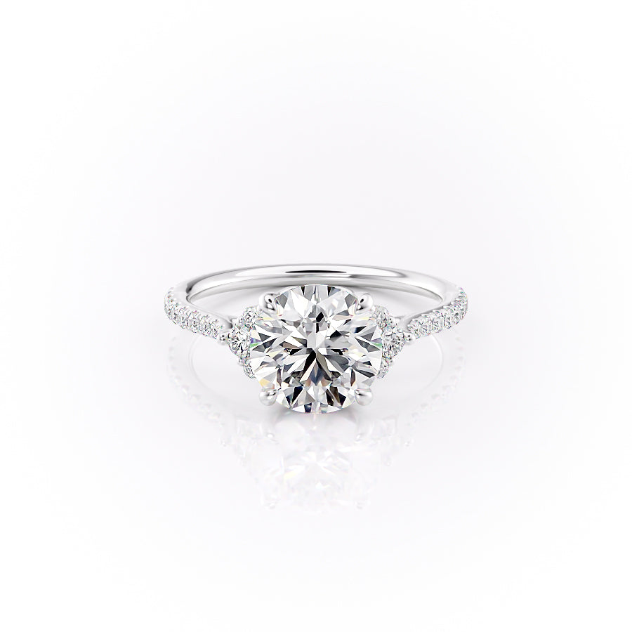 The Pave Victoria. A White Gold Three Stone, Side Stones Engagement Ring Set With A 2ct Round Lab Grown Diamond. White Background.