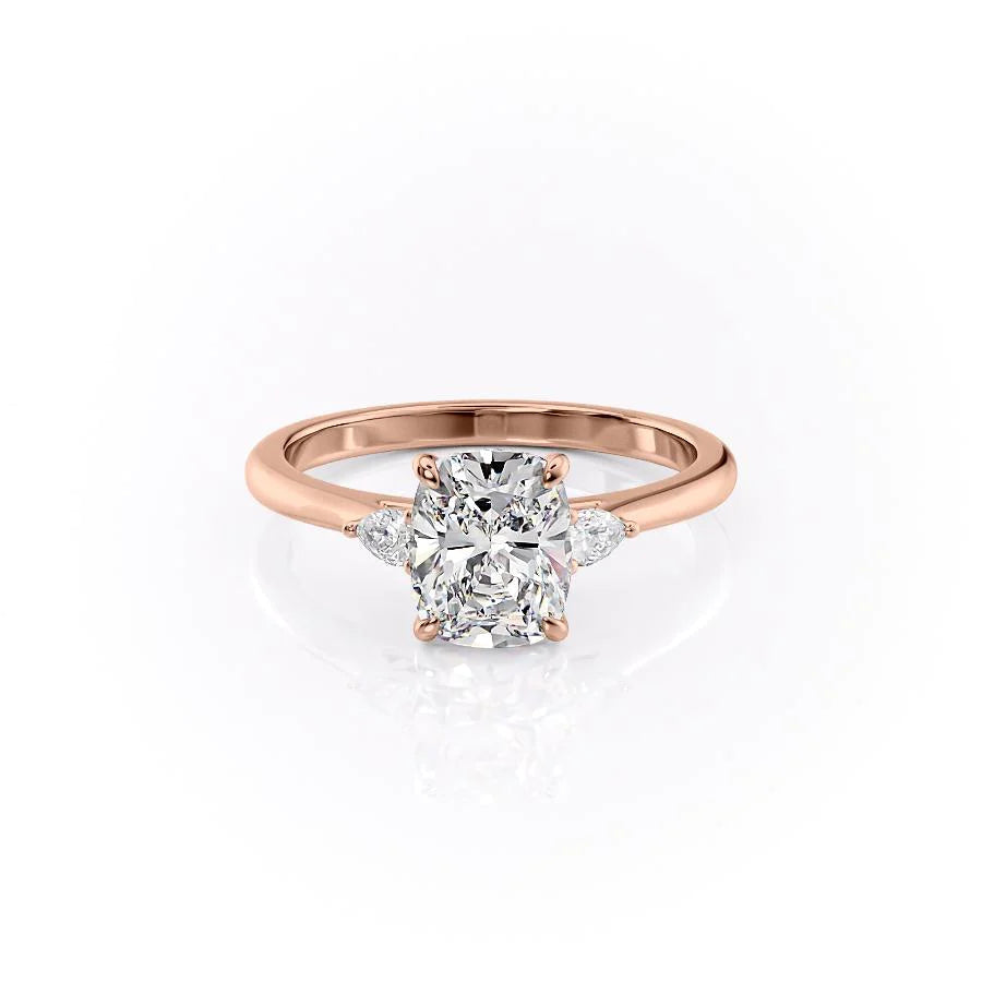 The Pears Liv. A Rose Gold Three Stone Engagement Ring Set With A 2ct Elongated Cushion Lab Grown Diamond. White Background.