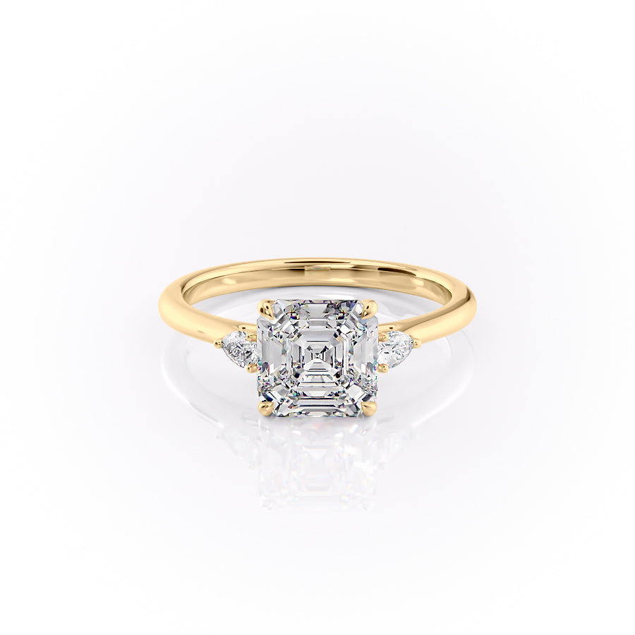 The Pears Liv. A Yellow Gold Three Stone Engagement Ring Set With A 2ct Asscher Lab Grown Diamond. White Background.
