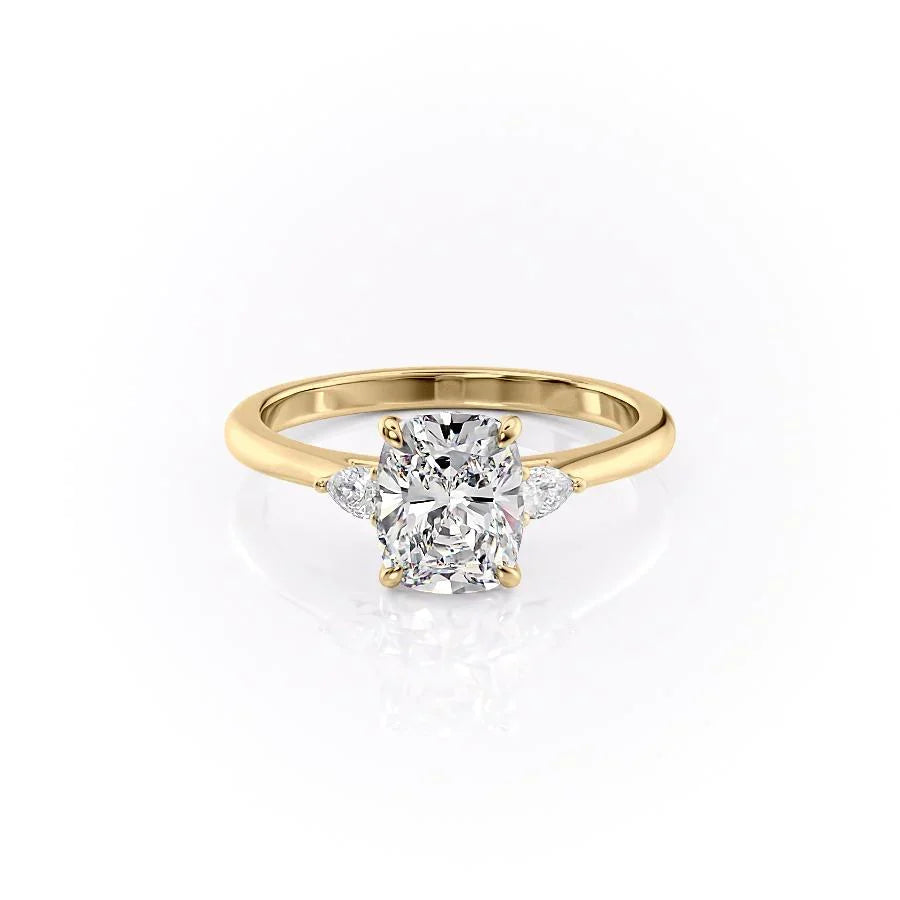 The Pears Liv. A Yellow Gold Three Stone Engagement Ring Set With A 2ct Elongated Cushion Lab Grown Diamond. White Background.