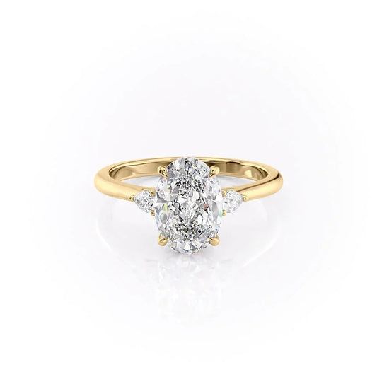 The Pears Liv. A Yellow Gold Three Stone Engagement Ring Set With A 2ct Oval Lab Grown Diamond. White Background.
