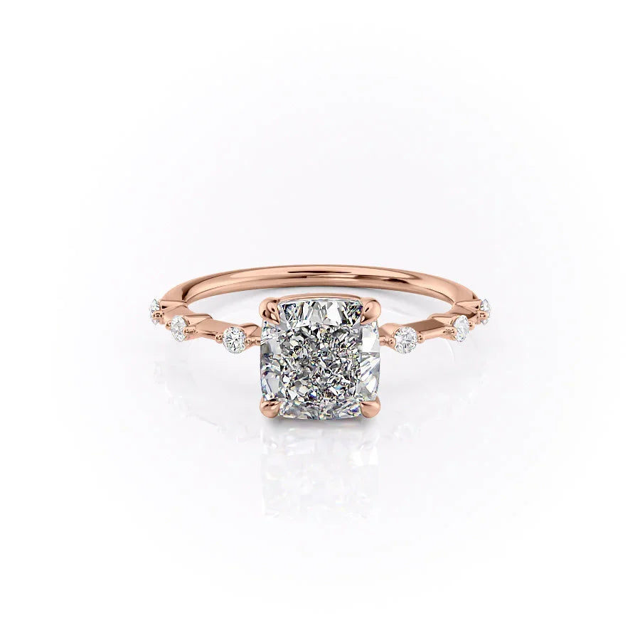 The Penelope. A Rose Gold Solitaire, Side Stones Engagement Ring Set With A 2ct Cushion Lab Grown Diamond. White Background.