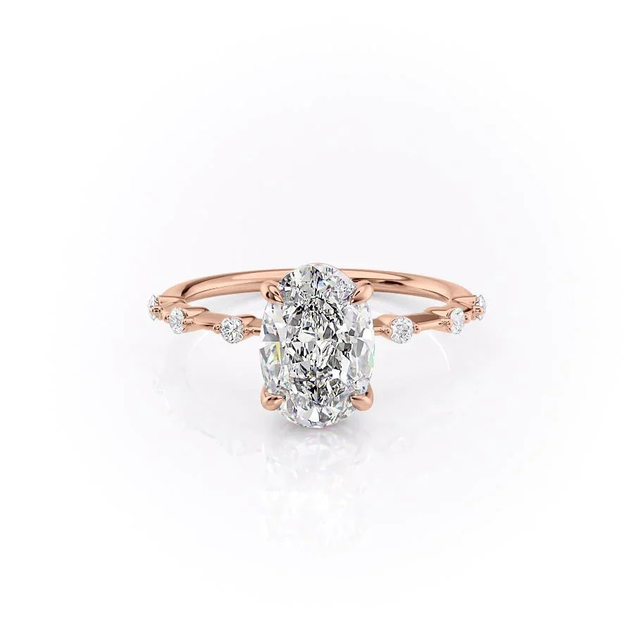 The Penelope. A Rose Gold Solitaire, Side Stones Engagement Ring Set With A 2ct Oval Lab Grown Diamond. White Background.