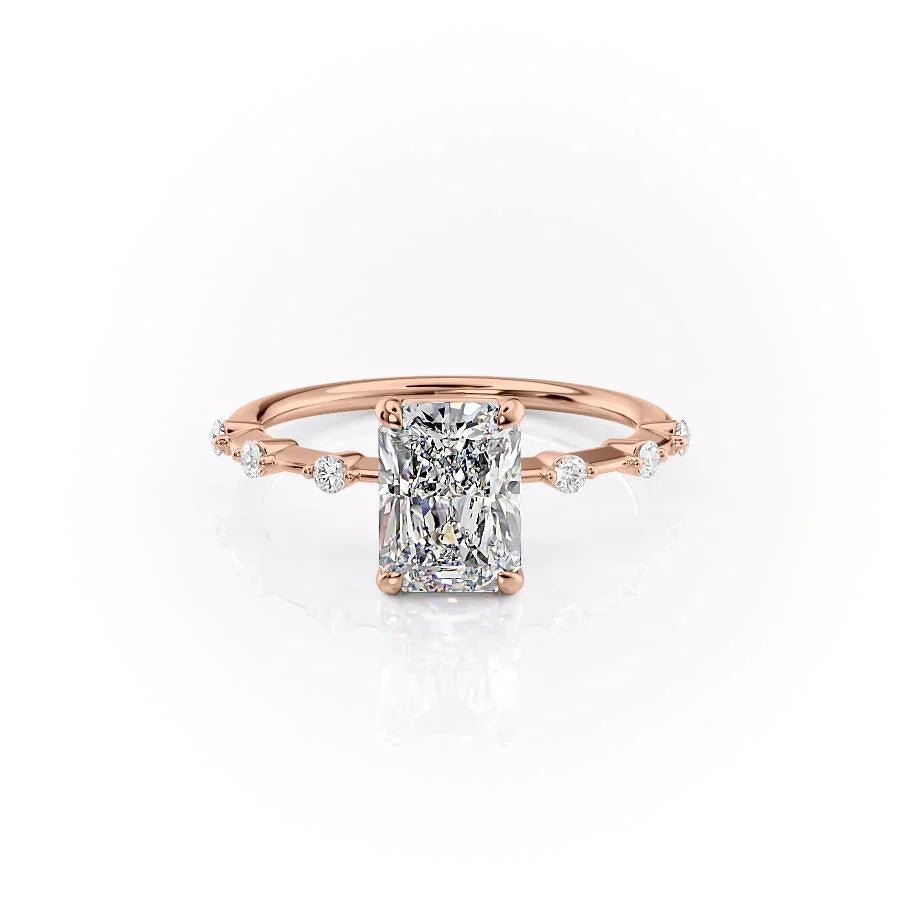 The Penelope. A Rose Gold Solitaire, Side Stones Engagement Ring Set With A 2ct Radiant Lab Grown Diamond. White Background.