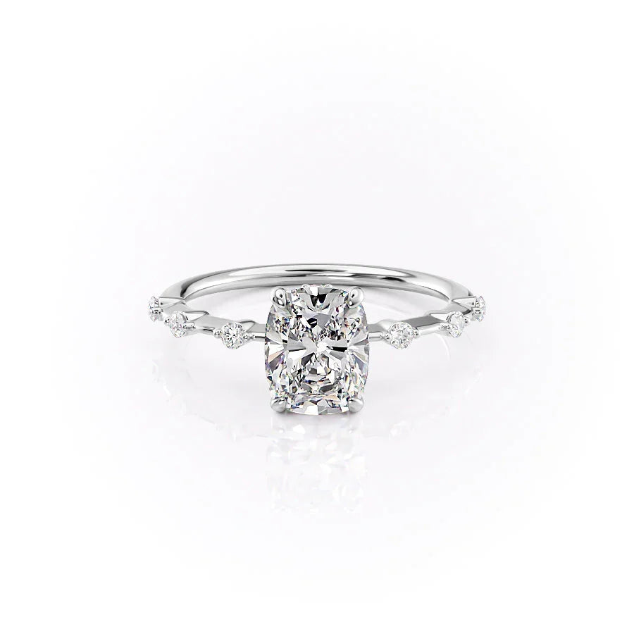 The Penelope. A White Gold Solitaire, Side Stones Engagement Ring Set With A 2ct Elongated Cushion Lab Grown Diamond. White Background.