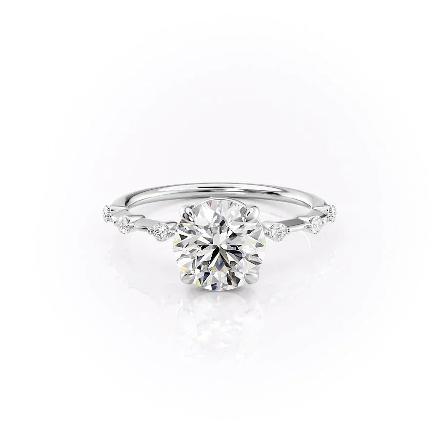 The Penelope. A White Gold Solitaire, Side Stones Engagement Ring Set With A 2ct Round Lab Grown Diamond. White Background.