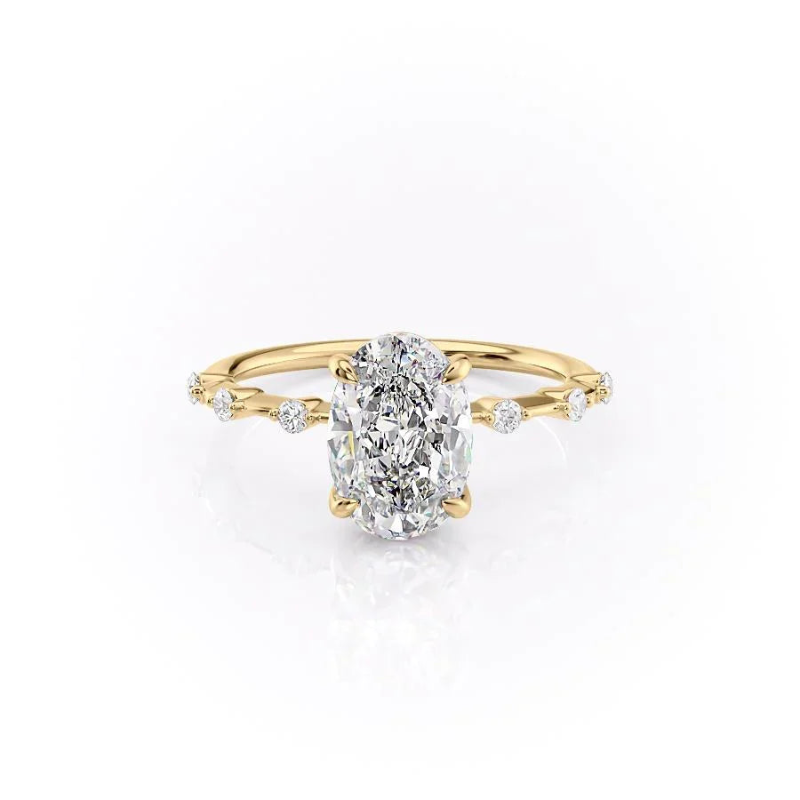 The Penelope. A Yellow Gold Solitaire, Side Stones Engagement Ring Set With A 2ct Oval Lab Grown Diamond. White Background.