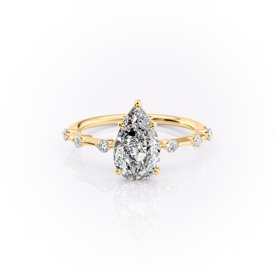 The Penelope. A Yellow Gold Solitaire, Side Stones Engagement Ring Set With A 2ct Pear Lab Grown Diamond. White Background.