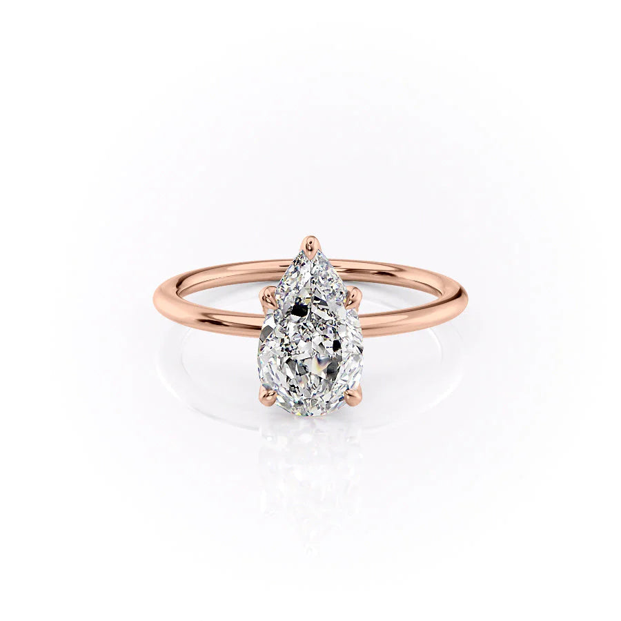 The Petal Kamellie. A Rose Gold Solitaire, Nature Engagement Ring Set With A 2ct Pear Lab Grown Diamond. White Background.