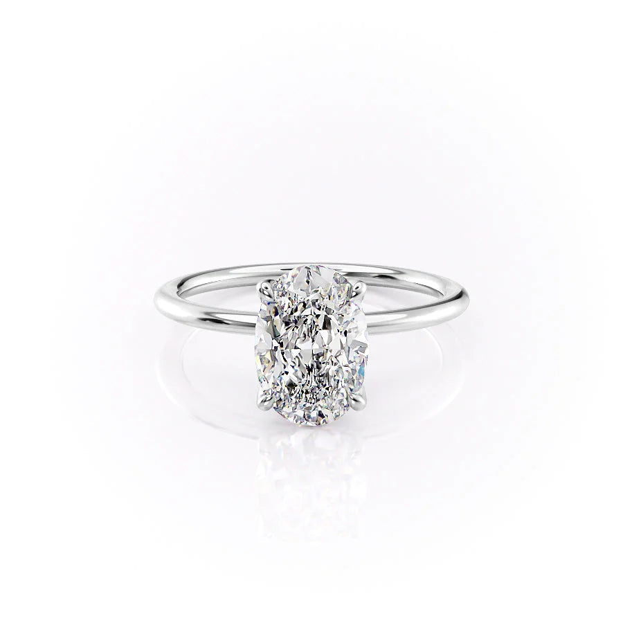 The Petal Kamellie. A White Gold Solitaire, Nature Engagement Ring Set With A 2ct Oval Lab Grown Diamond. White Background.