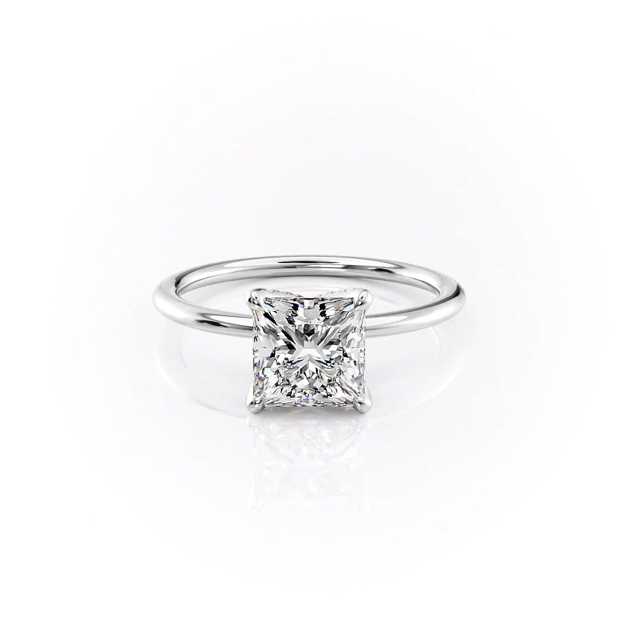 The Petal Kamellie. A White Gold Solitaire, Nature Engagement Ring Set With A 2ct Princess Lab Grown Diamond. White Background.