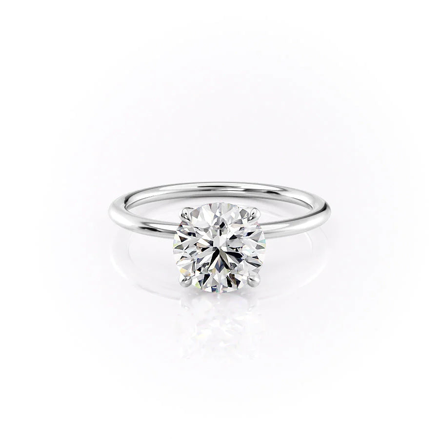 The Petal Kamellie. A White Gold Solitaire, Nature Engagement Ring Set With A 2ct Round Lab Grown Diamond. White Background.