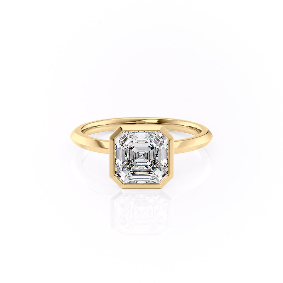 The Razor Bezel Kamellie. A Yellow Gold Solitaire Engagement Ring Set With A 2ct Asscher Lab Grown Diamond. White Background.