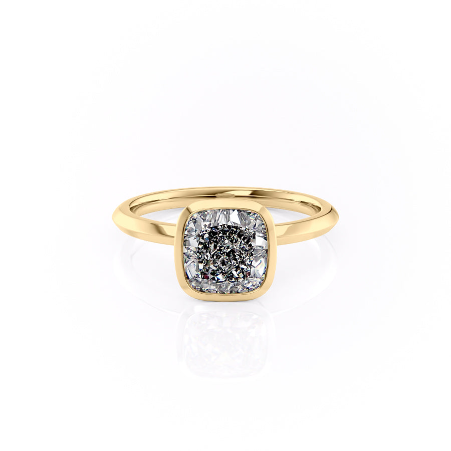 The Razor Bezel Kamellie. A Yellow Gold Solitaire Engagement Ring Set With A 2ct Cushion Lab Grown Diamond. White Background.