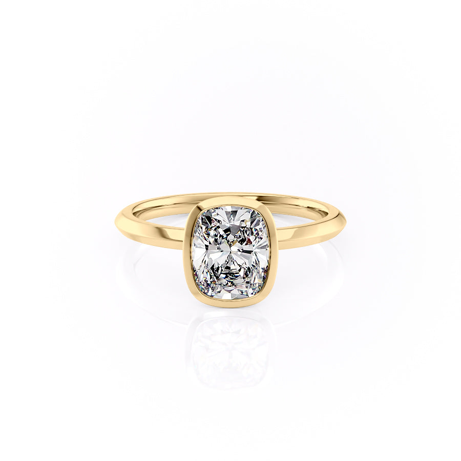 The Razor Bezel Kamellie. A Yellow Gold Solitaire Engagement Ring Set With A 2ct Elongated Cushion Lab Grown Diamond. White Background.
