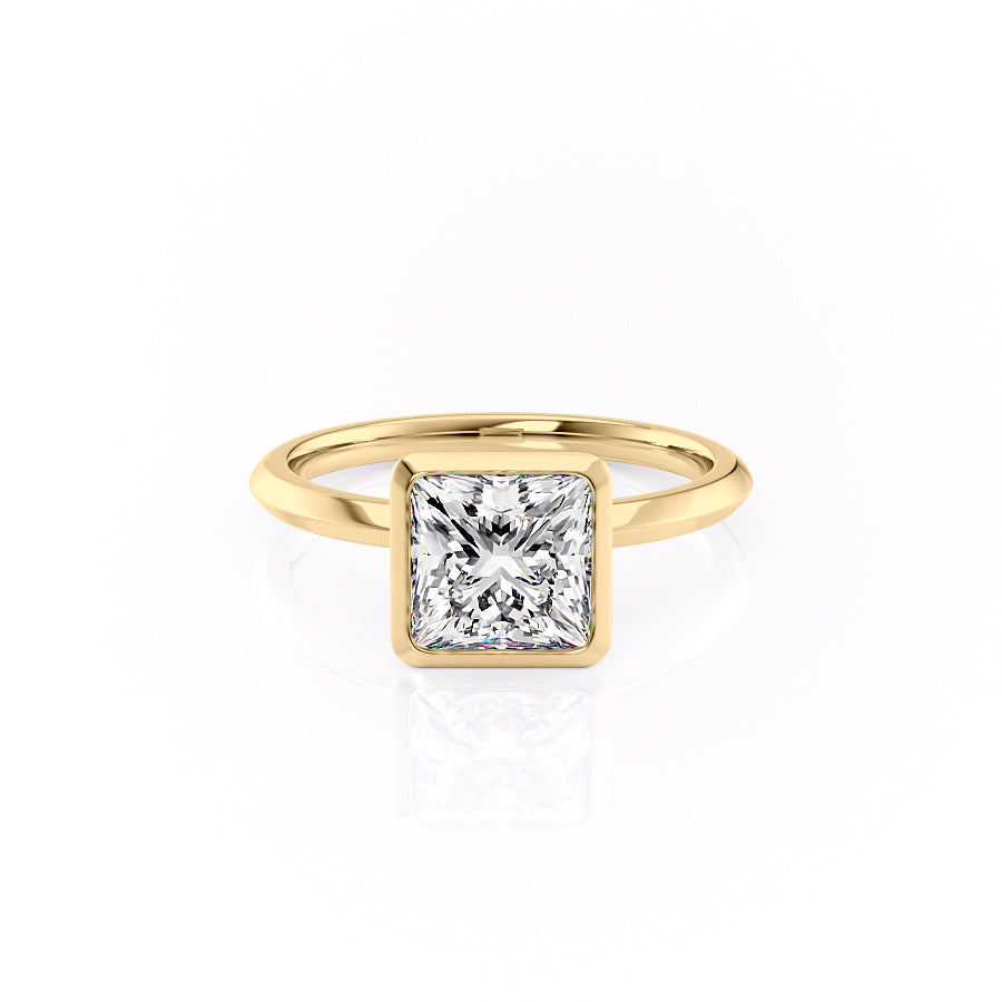 The Razor Bezel Kamellie. A Yellow Gold Solitaire Engagement Ring Set With A 2ct Princess Lab Grown Diamond. White Background.