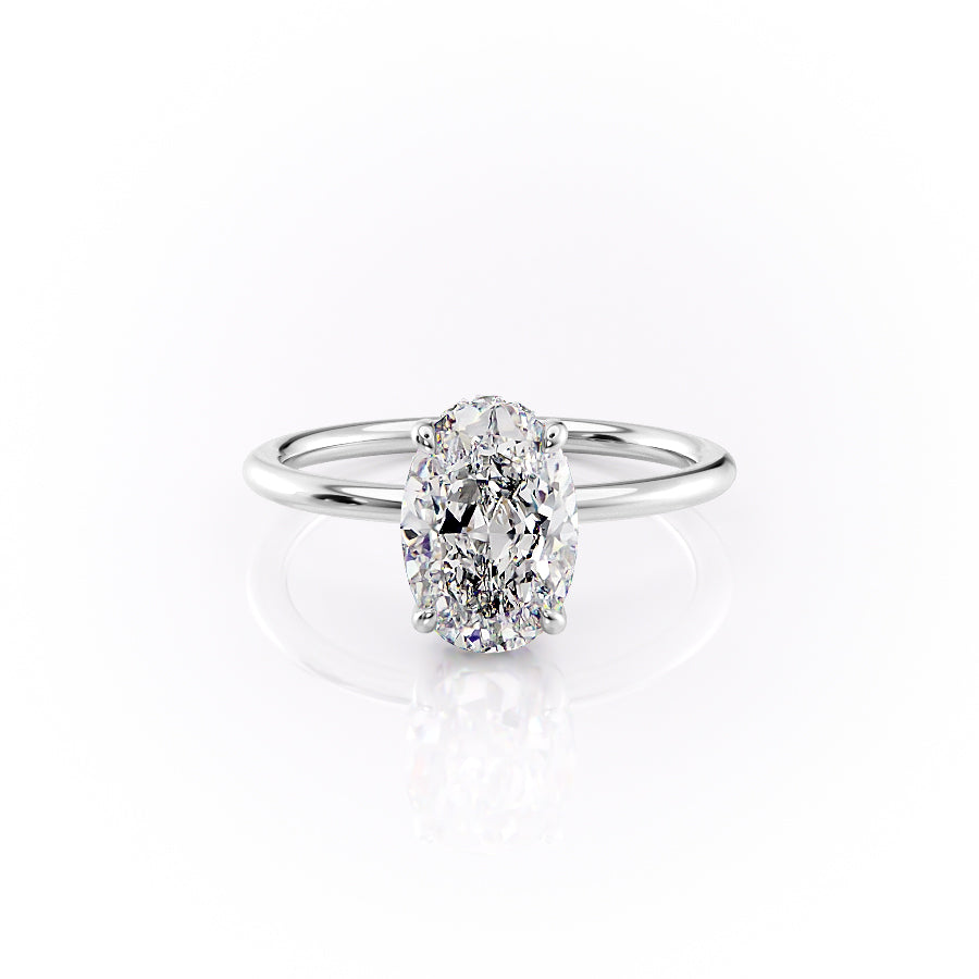 The Sandra. A White Gold Solitaire, Hidden Halo Engagement Ring Set With A 2ct Oval Lab Grown Diamond. White Background.