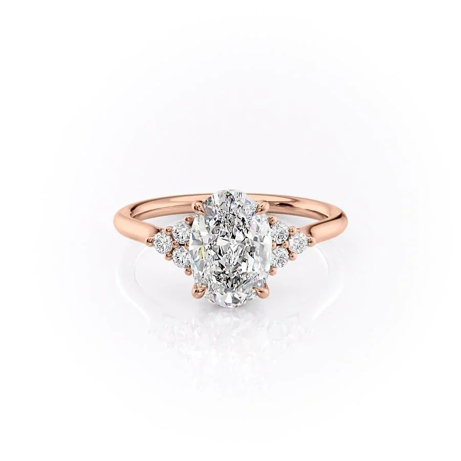 The Scarlett. A Rose Gold Side Stones, Three Stone Engagement Ring Set With A 2ct Oval Lab Grown Diamond. White Background.